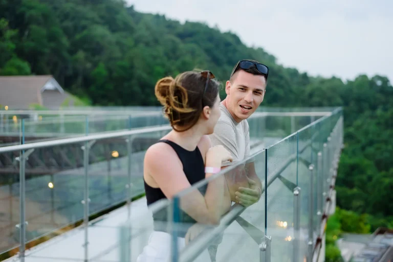 A couple enjoying a warm and happy conversation while watching the sunset at Samet Nangshi Beyond Skywalk